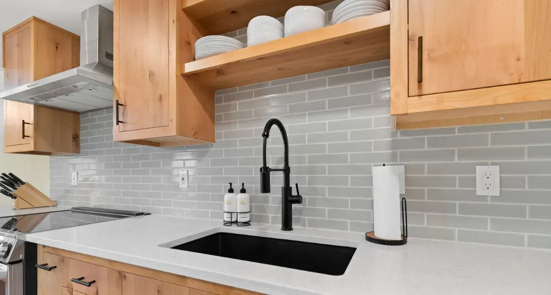A spring faucet and black sink